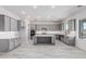 Spacious kitchen with gray cabinets, a large center island, and stainless steel appliances at 17322 W Puget Ave, Waddell, AZ 85355