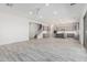 Open-concept kitchen and living area with modern gray cabinets and recessed lighting at 17322 W Puget Ave, Waddell, AZ 85355