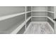 Walk-in pantry with shelving and light wood-look flooring at 17322 W Puget Ave, Waddell, AZ 85355
