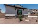 Side view of charming two-story home featuring desert landscaping and a stone-accented facade at 17322 W Puget Ave, Waddell, AZ 85355