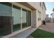 Backyard patio with sliding glass doors leading to the house at 1799 N 209Th Ave, Buckeye, AZ 85396
