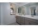 Bright bathroom vanity with double sinks, mirrors, and natural light from a window at 1799 N 209Th Ave, Buckeye, AZ 85396