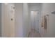 Clean and white bathroom interior with tile shower, vanity, and light wood look flooring at 1799 N 209Th Ave, Buckeye, AZ 85396