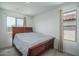 Bedroom features a wooden bed, carpet, and two windows providing natural light at 1799 N 209Th Ave, Buckeye, AZ 85396