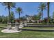 Beautiful community park with manicured lawns, a charming gazebo, and mature palm trees under a clear blue sky at 1799 N 209Th Ave, Buckeye, AZ 85396
