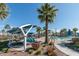 Beautiful community pool area with palm trees, lounge chairs, and shaded seating for residents to enjoy at 1799 N 209Th Ave, Buckeye, AZ 85396