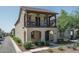 Charming two-story home featuring a balcony, landscaped front yard, and a covered entryway, offering curb appeal at 1799 N 209Th Ave, Buckeye, AZ 85396