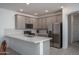Modern kitchen featuring stainless steel appliances, sleek countertops, and ample cabinet space for storage at 1799 N 209Th Ave, Buckeye, AZ 85396