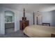 Spacious main bedroom showcasing a dark wood dresser and bathroom at 1799 N 209Th Ave, Buckeye, AZ 85396