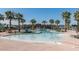 Large community pool area with palm trees and lounge chairs at 1799 N 209Th Ave, Buckeye, AZ 85396