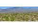 Breathtaking aerial view of a residential community nestled amidst lush greenery and majestic mountains at 2304 Fox Tail Trl, Carefree, AZ 85377