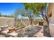 Backyard oasis with mature trees, desert landscaping, and a charming garden area at 2304 Fox Tail Trl, Carefree, AZ 85377