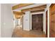 Open entryway featuring brick floors, wood-beamed ceilings, and a stunning double door at 2304 Fox Tail Trl, Carefree, AZ 85377
