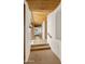 Inviting hallway with wood ceiling, tile floors, and natural light creating a warm and stylish transition at 2304 Fox Tail Trl, Carefree, AZ 85377