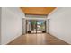 Bright living room with hardwood floors and large glass doors leading to an outdoor patio at 2304 Fox Tail Trl, Carefree, AZ 85377