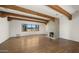 Spacious living room features a charming fireplace, wood beam ceilings, and hardwood floors at 2304 Fox Tail Trl, Carefree, AZ 85377