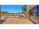 Outdoor entertaining area with a built-in grill, desert landscaping, and natural stone accents at 2304 Fox Tail Trl, Carefree, AZ 85377