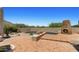 Serene backyard pool with a brick patio, a fireplace, and views of desert landscaping at 2304 Fox Tail Trl, Carefree, AZ 85377