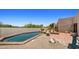 Beautiful backyard pool with desert landscaping, a fireplace, and space for outdoor entertaining at 2304 Fox Tail Trl, Carefree, AZ 85377