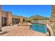 Gorgeous backyard with a pool, desert landscaping, and a mountain view in the background at 2304 Fox Tail Trl, Carefree, AZ 85377