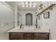 Bathroom featuring double vanity, framed mirror, decorative accents, and a separate shower with glass door at 2540 N 148Th Dr, Goodyear, AZ 85395