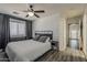 Comfortable bedroom with hard wood floors, a modern bed, and white wood paneling at 2540 N 148Th Dr, Goodyear, AZ 85395