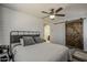 Stylish bedroom featuring shiplap accent wall, a sliding barn door, and a view of an en-suite bathroom at 2540 N 148Th Dr, Goodyear, AZ 85395