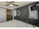Stylish bedroom featuring a sliding barn door, dark gray wall, modern clock, and 2 windows at 2540 N 148Th Dr, Goodyear, AZ 85395
