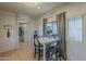 Bright kitchen featuring tile floors, and a casual dining area leading into the hall and bathroom at 2540 N 148Th Dr, Goodyear, AZ 85395