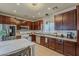 Traditional kitchen features dark wood cabinetry and stainless steel appliances at 2540 N 148Th Dr, Goodyear, AZ 85395