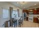 Bright kitchen featuring tile floors, stainless steel appliances, and a casual dining area with a view at 2540 N 148Th Dr, Goodyear, AZ 85395
