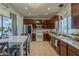 Well-lit kitchen with tile floors, modern appliances, and a dining area at 2540 N 148Th Dr, Goodyear, AZ 85395