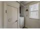 Functional laundry room with washer, window with blinds, and charming decorative safety pin at 2540 N 148Th Dr, Goodyear, AZ 85395
