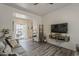 Stylish living room with gray couches and an opening to a bright patio at 2540 N 148Th Dr, Goodyear, AZ 85395