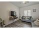 Living room features a sleek TV setup and minimalist decor at 2540 N 148Th Dr, Goodyear, AZ 85395