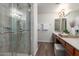 Bathroom featuring granite countertop, double sinks, and modern glass-enclosed shower at 2635 N El Dorado Pl, Chandler, AZ 85224