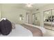 Bright bedroom with a ceiling fan, closet with mirrored doors, and a king-sized bed at 2635 N El Dorado Pl, Chandler, AZ 85224