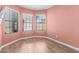 Bright bedroom featuring beautiful wood floors and natural light from three windows at 2635 N El Dorado Pl, Chandler, AZ 85224