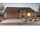 Charming single-story home with a stone facade, tile roof, and well-manicured landscaping at 26651 W Kimberly Way, Buckeye, AZ 85396