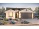 Charming single-story home featuring a two-car garage, a desert landscaped front yard, and a decorative door at 26929 W Melinda Ln, Buckeye, AZ 85396