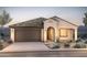 Charming single-story home with a tile roof, desert landscaping, and a two-car garage at 26938 W Rosemonte Dr, Buckeye, AZ 85396