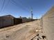 Showing an alleyway between residential homes and block fencing at 2745 E Wood St, Phoenix, AZ 85040