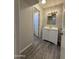 A bathroom showcasing a white vanity with a mirror, vinyl flooring, and access to an adjoining bedroom at 2745 E Wood St, Phoenix, AZ 85040