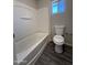 Standard bathroom with a shower-tub combination and modern gray vinyl flooring at 2745 E Wood St, Phoenix, AZ 85040