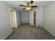 A bedroom with neutral walls and carpet leading to multiple rooms at 2745 E Wood St, Phoenix, AZ 85040