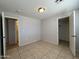 Bedroom boasts tile flooring, neutral walls, and two door entrances at 2745 E Wood St, Phoenix, AZ 85040