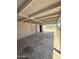 Large carport featuring a concrete floor, a secure metal gate, and ample room for parking and storage at 2745 E Wood St, Phoenix, AZ 85040