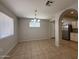 Sunlit dining area with a stylish chandelier and view into the modern kitchen at 2745 E Wood St, Phoenix, AZ 85040