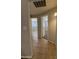 A hallway with doorways and tile flooring connects multiple rooms at 2745 E Wood St, Phoenix, AZ 85040