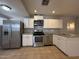 Stainless steel appliances and white cabinets define the well-appointed modern kitchen at 2745 E Wood St, Phoenix, AZ 85040